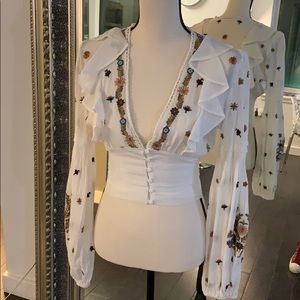 Linen blouse with embodied red flowers
